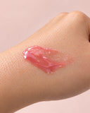 Chérie lip gloss swatch on skin — sheer pink
